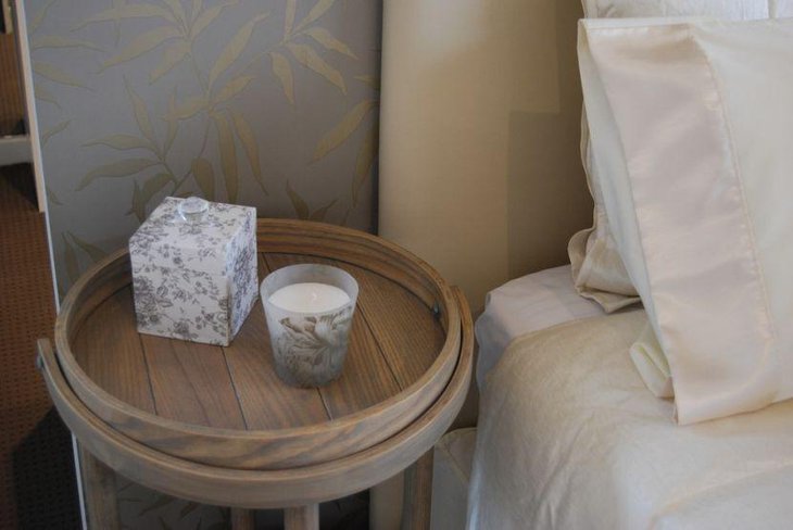 Ornamental candle in a votive displayed on the bedside table