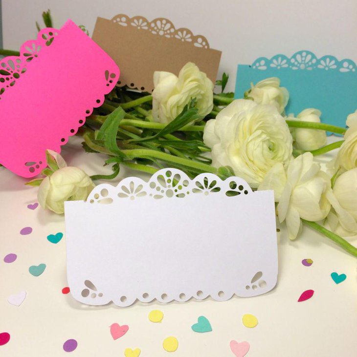Papel picado escort cards decorated with flowers