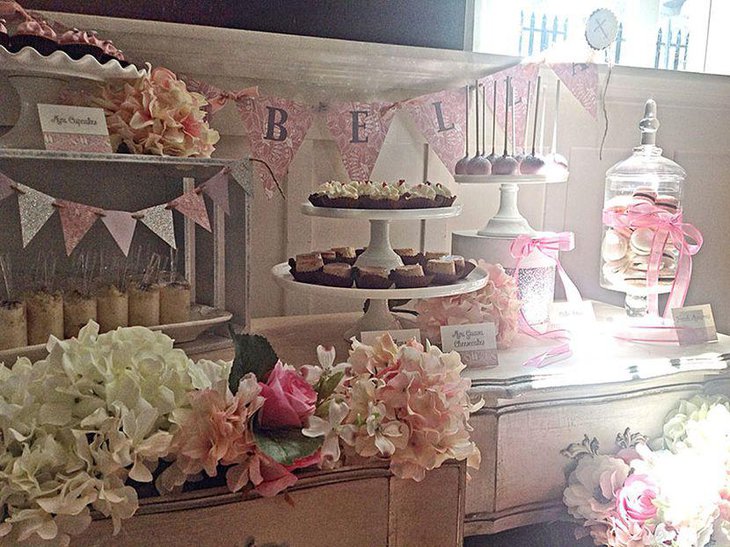 Pastel European dessert table with floral decoration