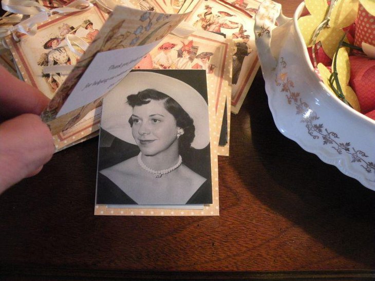 Pastel themed 80th birthday table for a mom is seen adorned with an old picture and DIY centerpiece