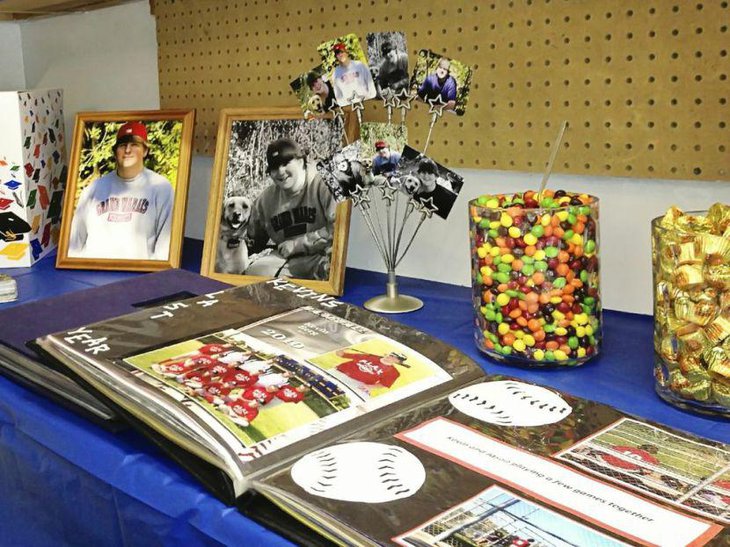 Photostand graduation centerpiece on garage themed graduation party table for guys