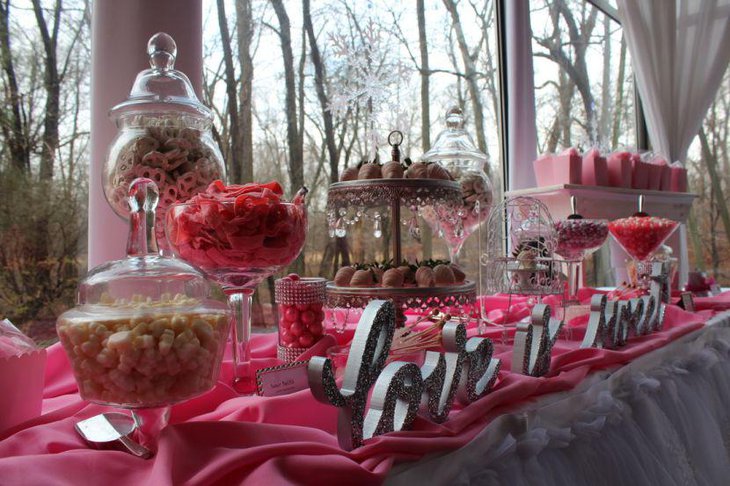 Pink accented winter wonderland baby shower dessert table