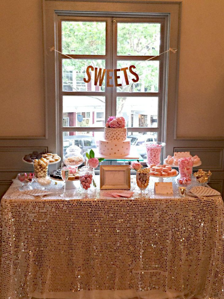 Pink and golden accented decorations on bridal shower table