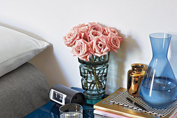 Pink rose decor on a bedside table for a feminine look