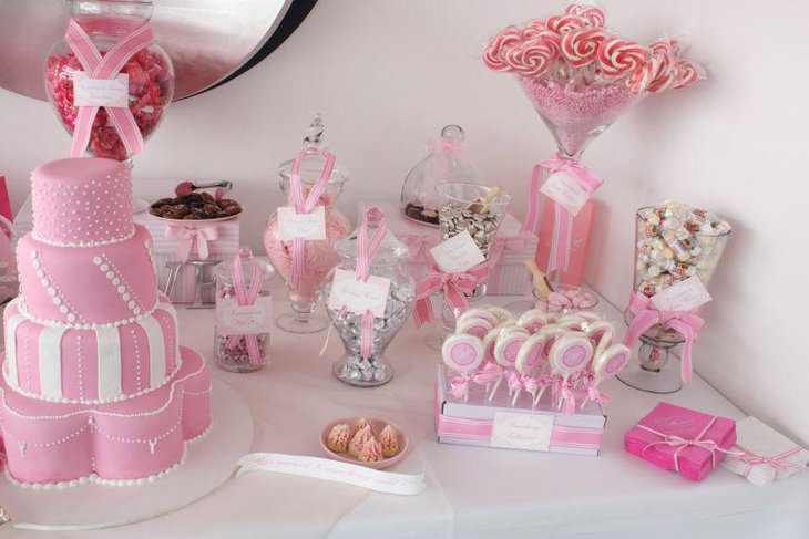 Pink wedding cake table embellishment with candy jars