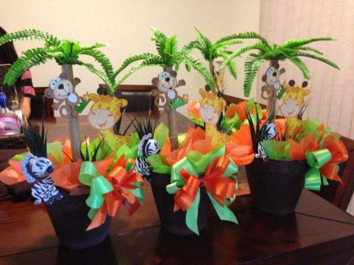 Pots decorated with animals and ribbons for safari jungle theme baby shower