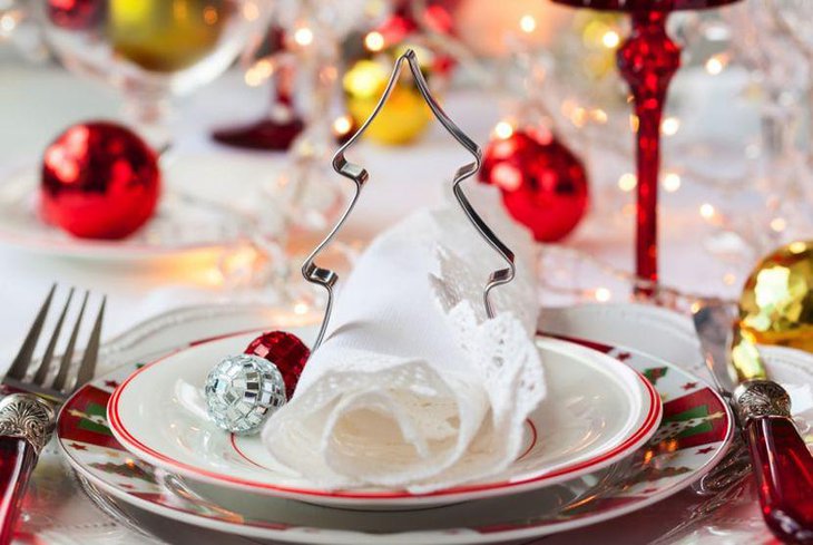 Pretty Christmas Table Setting With Silver Tree Cookie Cutter and Red Handle Silver Spoons