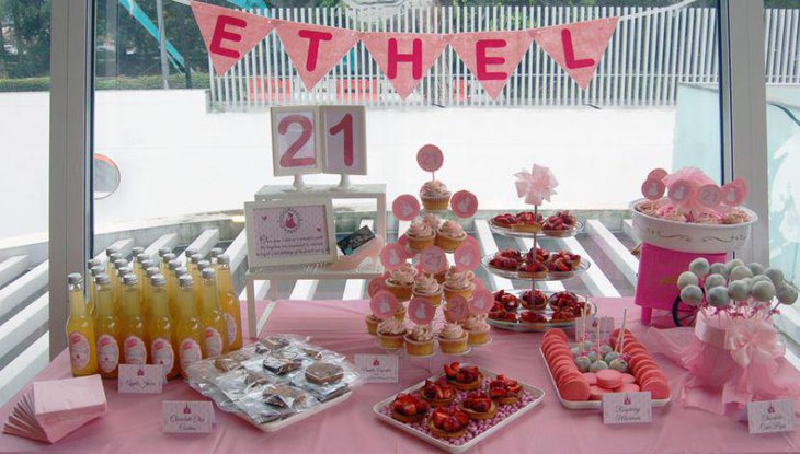 Pretty dessert table design with drinks. cookies and cupcakes