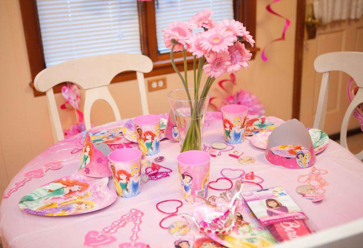 Pretty pink themed Disney Princess birthday party guest table setup