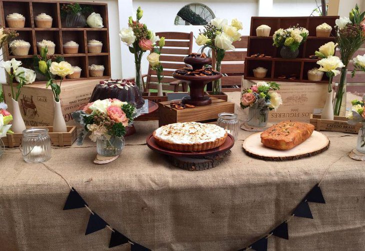 Pretty rustic dessert table with burlap and wood decorations