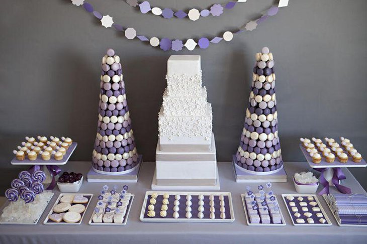 Purple and white macaron tower centerpieces on wedding candy table