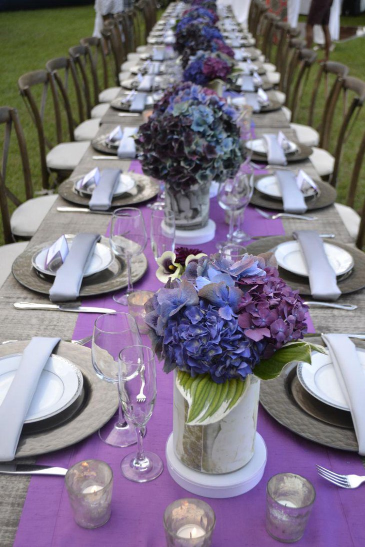Purple flower arrangements on birthday party table
