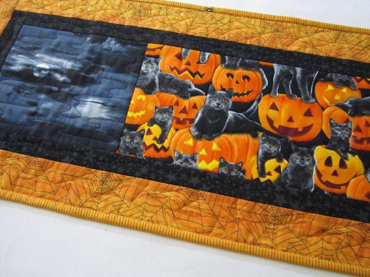 Quilted Halloween table runner with pumpkins and cats