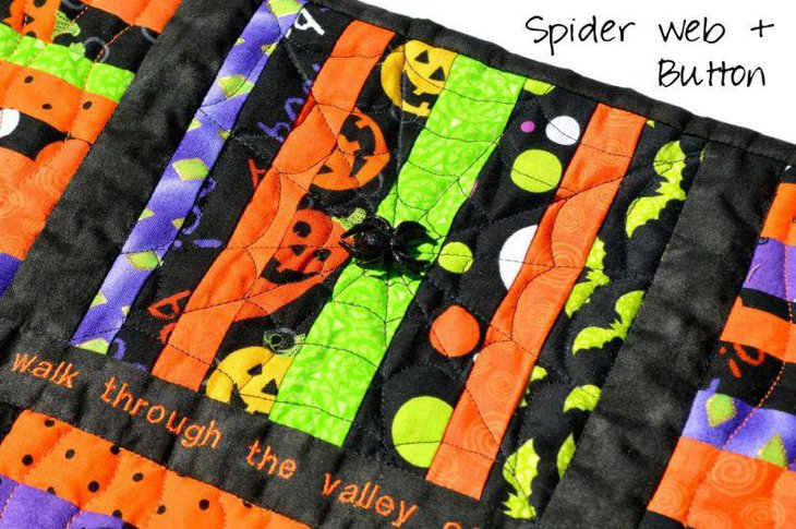 Quilted table runner with spiderwebs