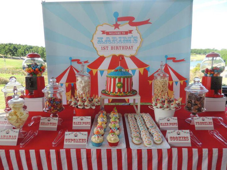 Red and white accented circus carnival themed boys first birthday table setting
