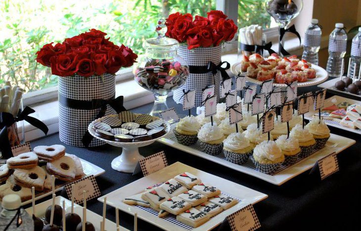 Red rose arrangement on adult birthday dessert table