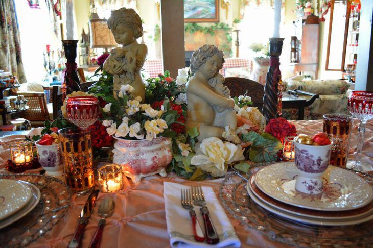 Romantic cherub with flower vignette setting on Valentines table