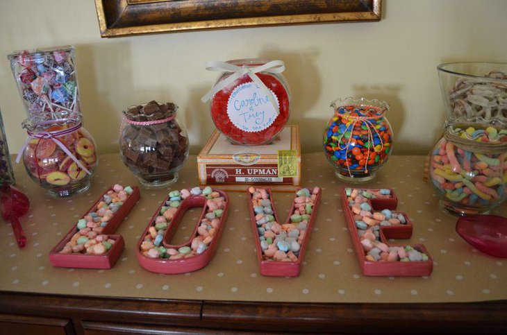 Romantic DIY wedding candy table setting with Valentines Day Letters filled with candies