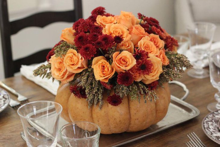 Roses in pumpkin centerpiece set up on a silver tray