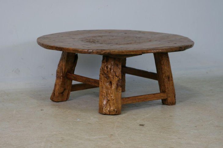 Round rustic coffee table with uneven legs