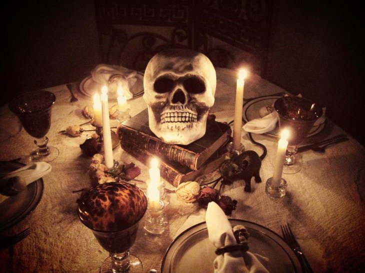 Scary skull and books decor on Halloween table