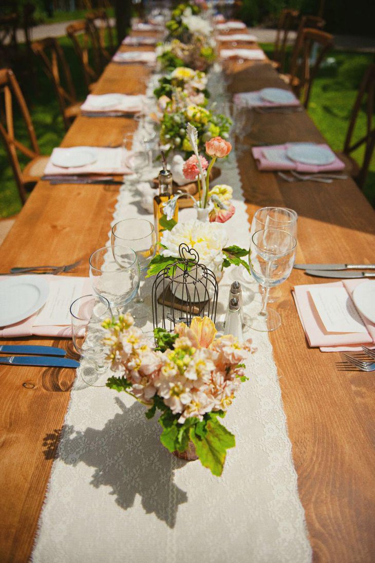 Simple floral country wedding table decked with rustic birdcage