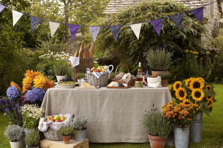 Simple garden party table setting with food in wicker baskets