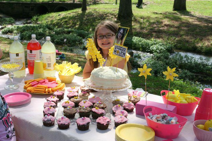 Spring garden birthday party table decked with yellow and pink accents