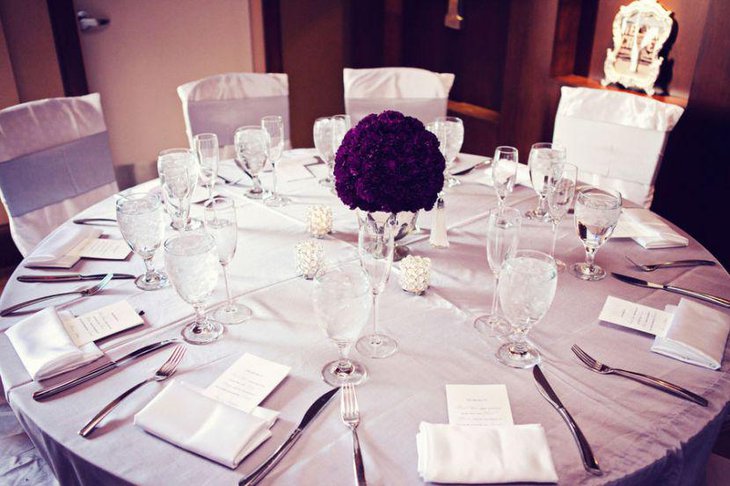 Stunning dark purple flower arrangement on wedding table