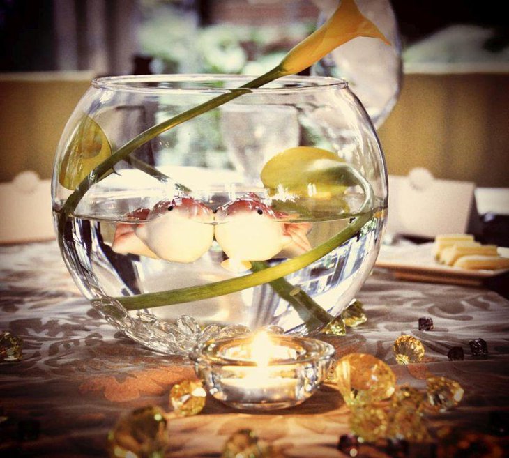Stunning fish bowl dining table centerpiece with fish and flower