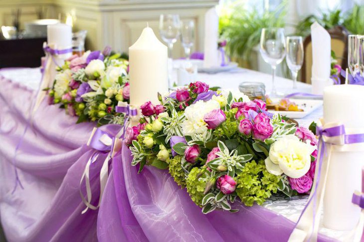 Stunning floral summer wedding table decor with candles