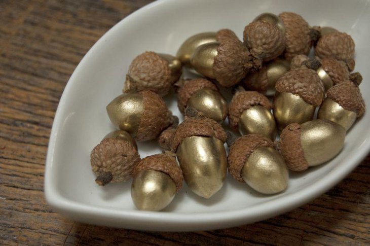 Stunning Golden Acorns On White Ceramic Bowl As Table Centerpiece