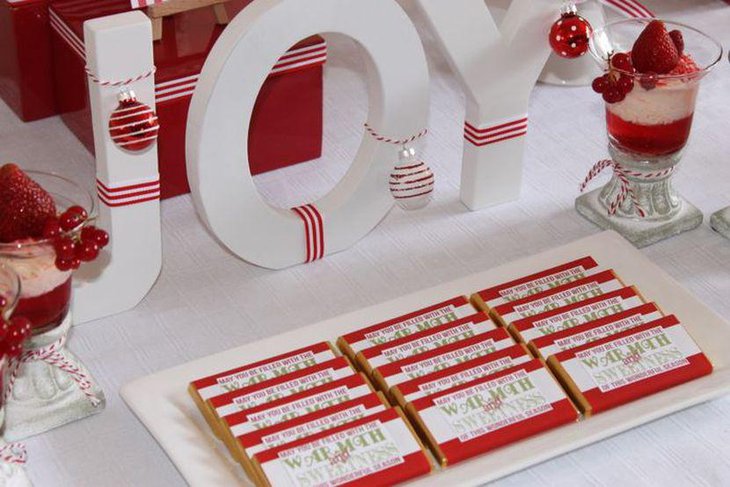 Stunning red and white kids Christmas dessert table with candy bars