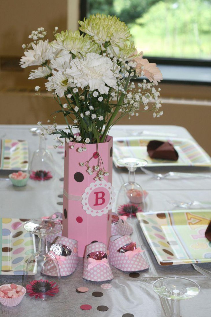Subtle flower decor for table with shoe paper cutouts for princess baby shower