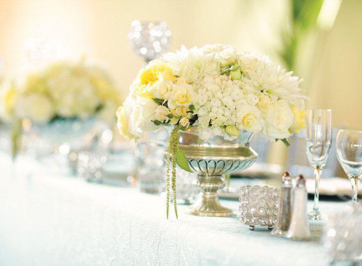 Summer wedding table decor with white and yellow floral centerpiece