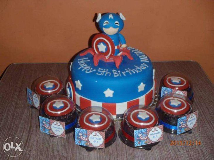 Sweet Avengers cupcakes and cakes laid out on a kids birthday party table