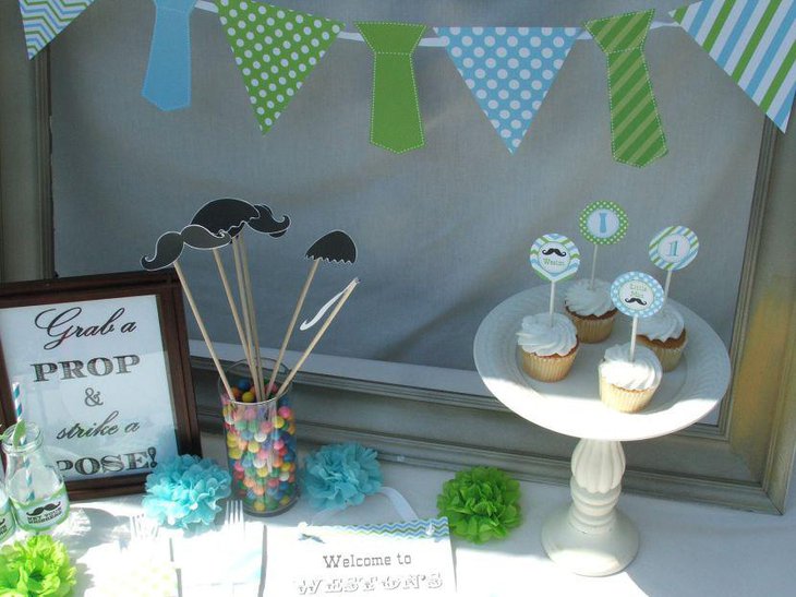 Sweet baby blue and lime accented Little Man Mustache theme on first birthday table decor
