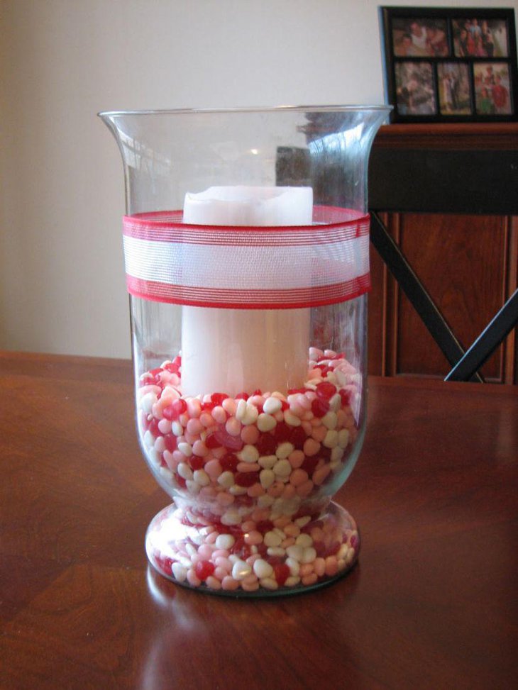 Sweet candy and candle in glass Valentine centerpiece