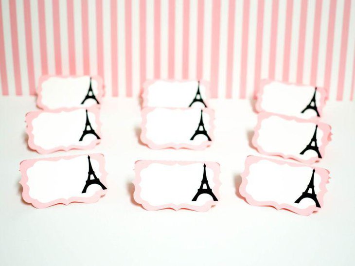 Sweet pink Eiffel Tower place cards on table