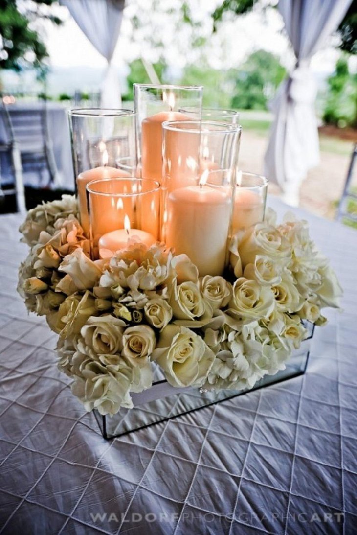 The Table Centerpiece for New Years Eve with Candles and Cream Flowers