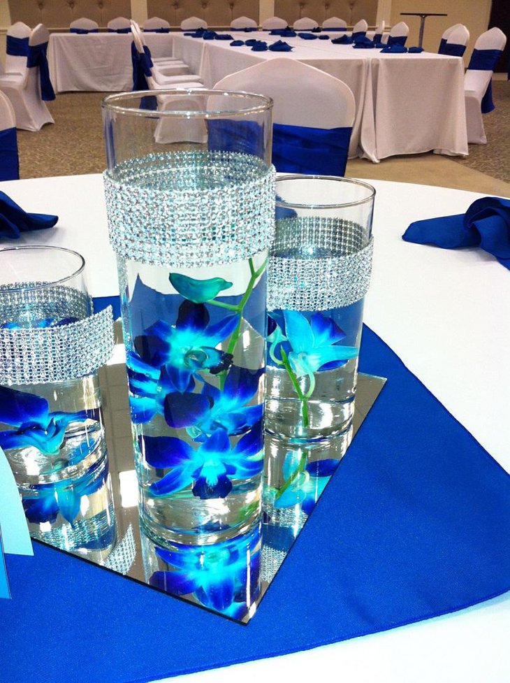 The Table Centerpiece for New Years Eve with Candles in Blue Flower Vase