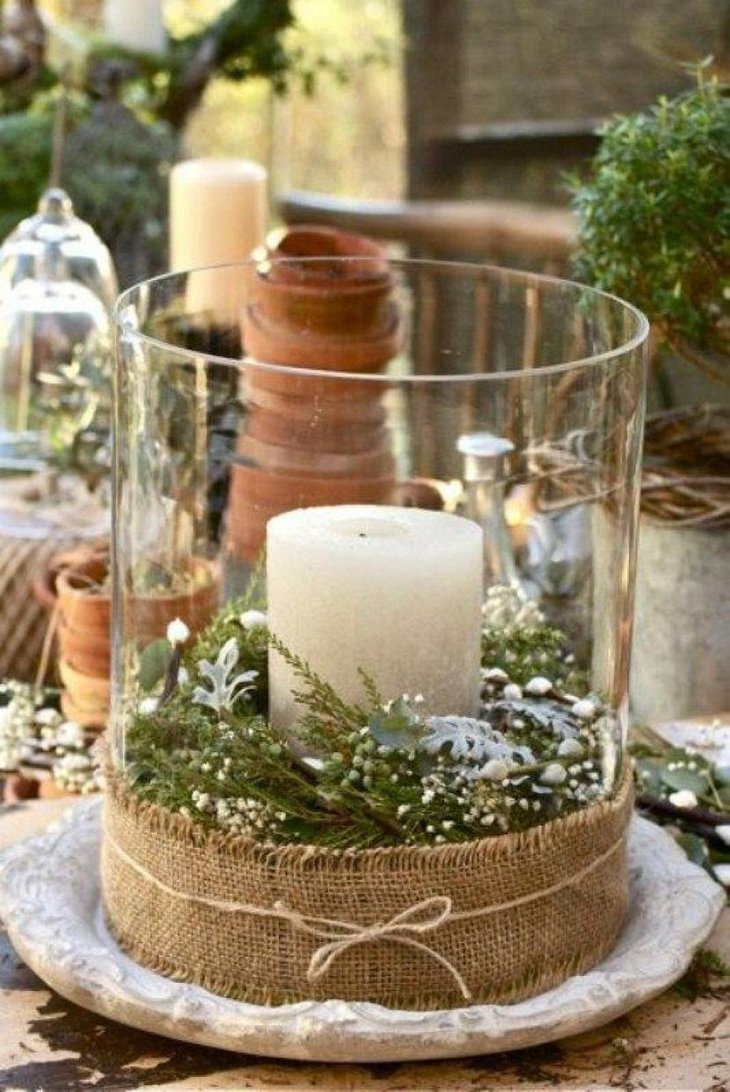 The Table Centerpiece for New Years Eve with Green Leaves and Candle