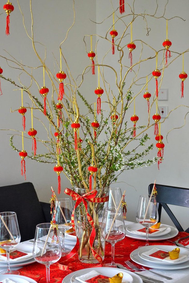 The Table Centerpiece for New Years Eve with Green Tree and Hanging Red Balls
