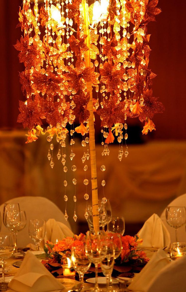The Table Centerpiece for New Years Eve with Hanging Crystals and Red Flowers
