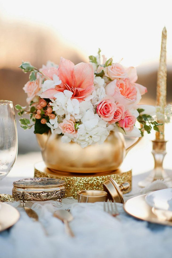 The Table Centerpiece for New Years Eve with Pink and White Flowers in Golden Vase