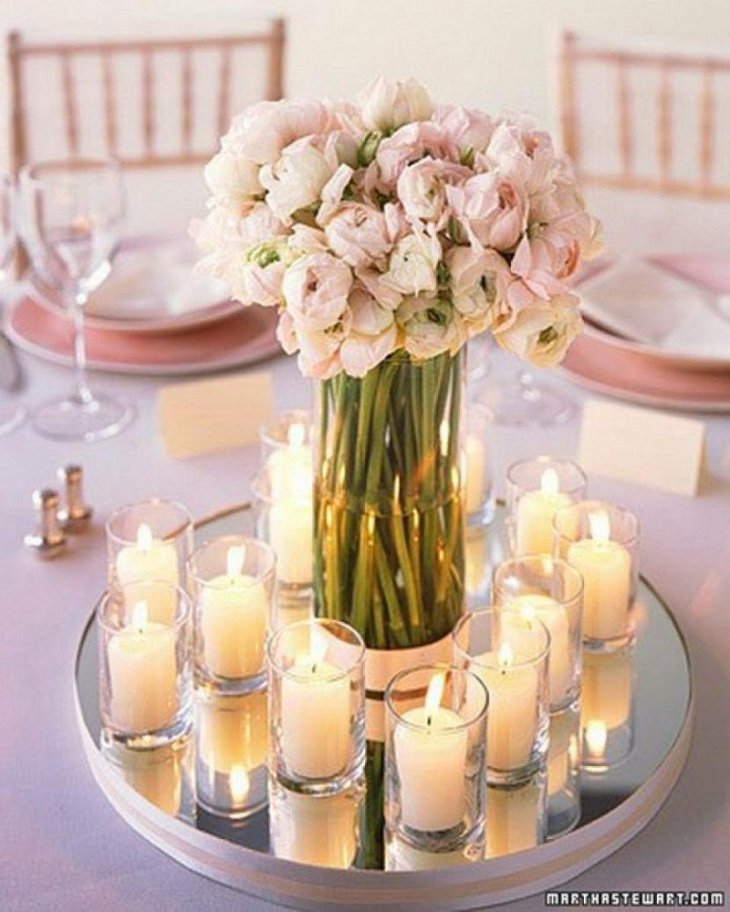 The Table Centerpiece for New Years Eve with Pink Flowers and Candles