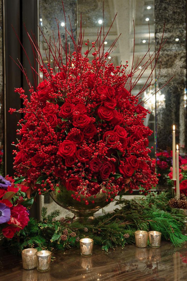 The Table Centerpiece for New Years Eve with Red Flowers and Green Leaves