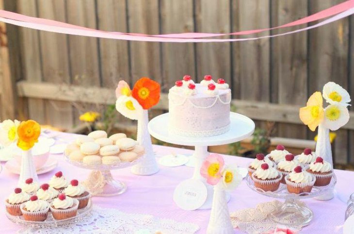 This bridal shower cake table looks stunning with colourful flowers