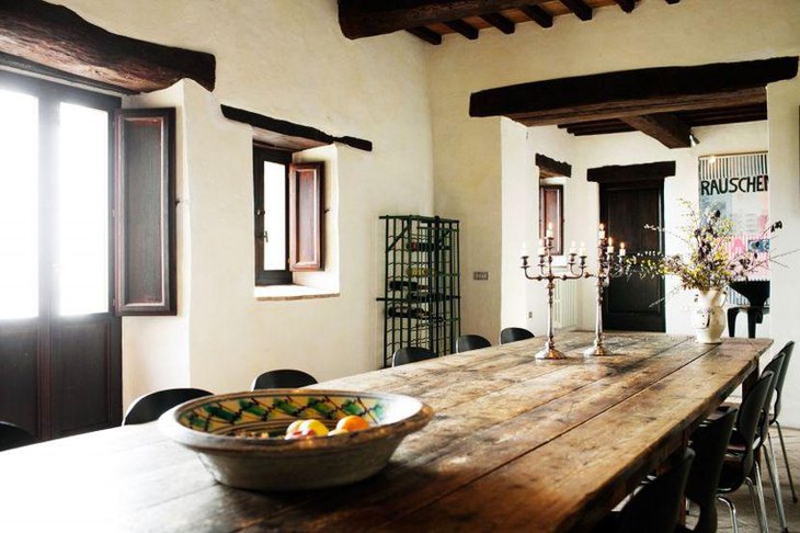 This Italian table has been decorated with rustic bowl and metal candelabras