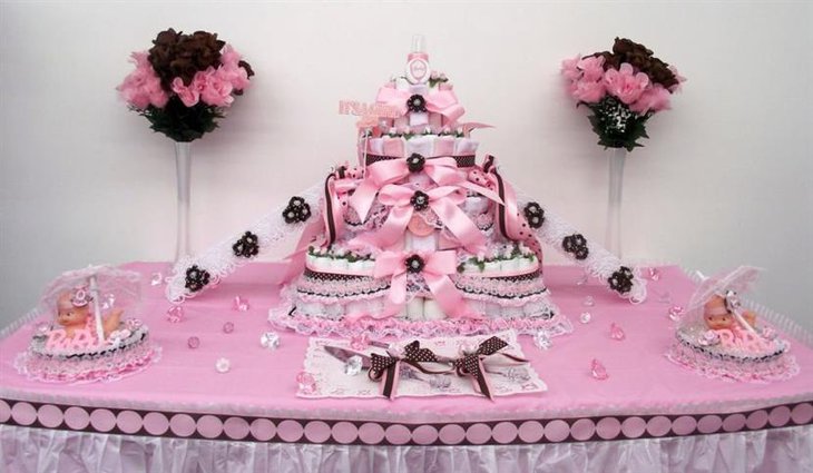 Tiered baby shower cake for a girl with pink ribbons